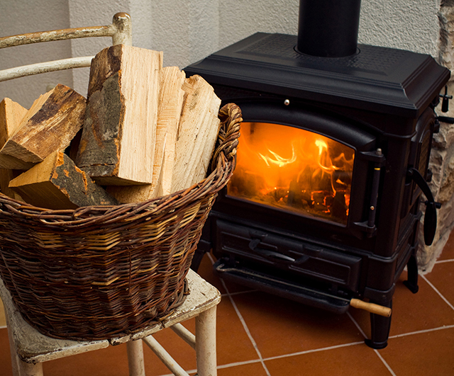 Basket full of logs in front of burning fire